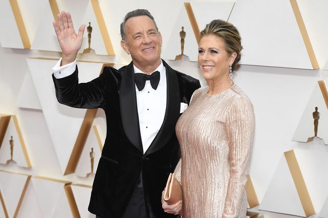 Tom Hanks in a tuxedo and Rita Wilson in a cream sequined gown